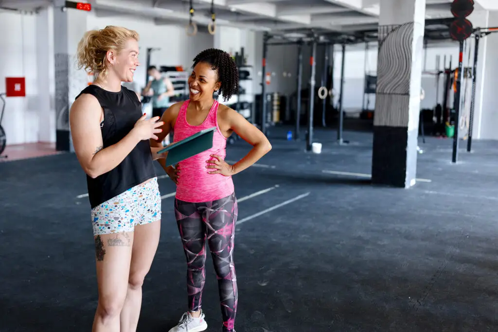 Coach welcoming a new woman in the gym
