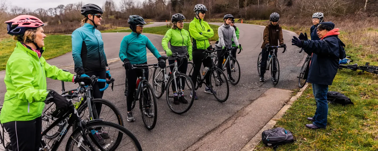 Cyclists A group of cyclists at the side of a road listening to a coach