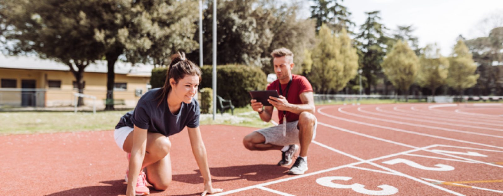 high performance sports coach coach with runner on the track