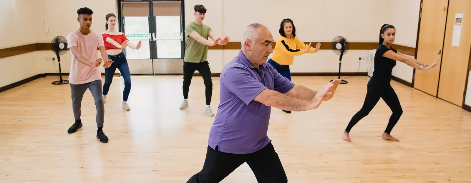 Teenagers in Tai Chi class with instructor