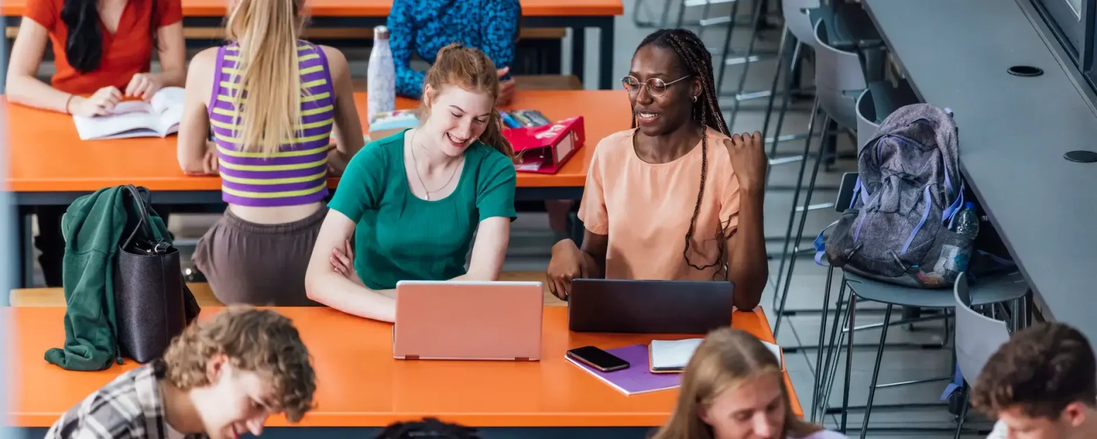 A group of students working together in a school common room.