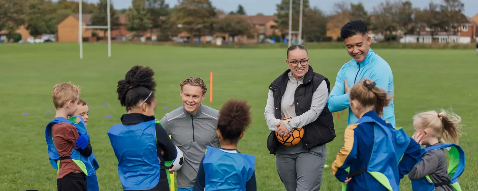 Under 10s’s Football Practise Coaches teaching a group of under 10's football on a pitch.